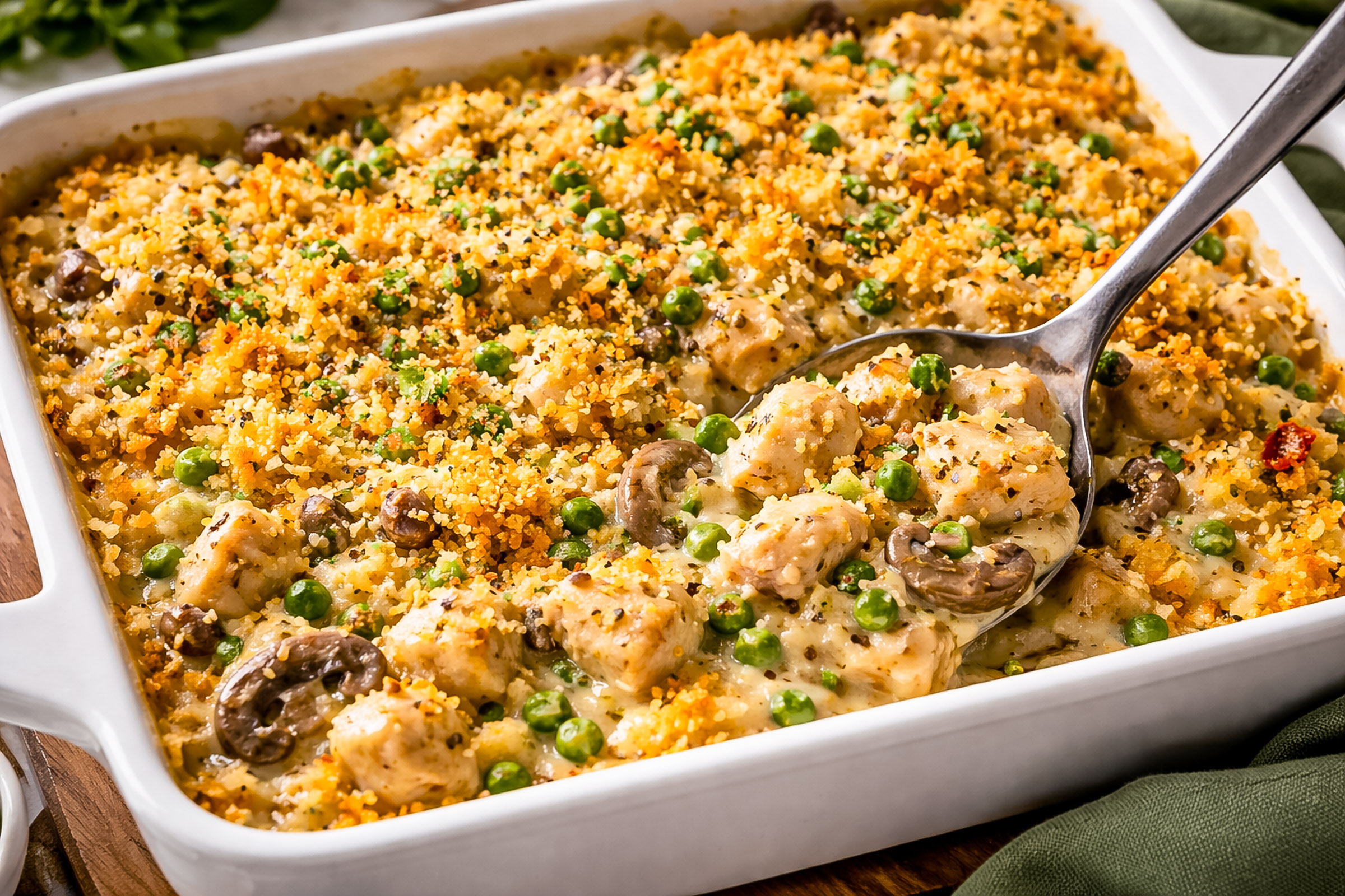 Bubbling creamy garlic chicken casserole with golden cheese top