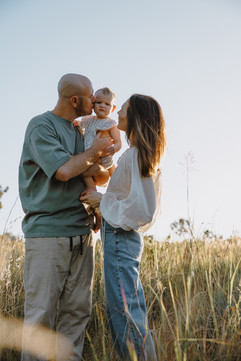Family standing in field of grass in a photography session near Yeppoon