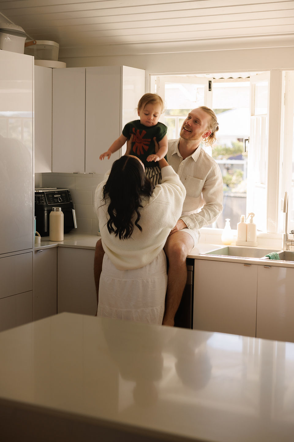 Rockhampton in-home photography session featuring parents with toddler in old Queenslander home