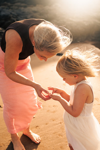 Mother and daughter looking at shell at Emu Park beach, taken during a family photoshoot with Sarah Joy, a Rockhampton Family Photographer