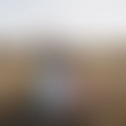 Mother sitting in the grass at Alkoomi Farmstay with her children 