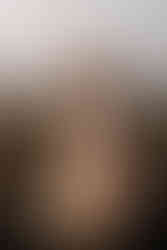 Pregnant lady in beautiful robe looking backwards during sunrise maternity and family photo session on Kemp Hill in Yeppoon, taken by Sarah Joy maternity Rockhampton photographer