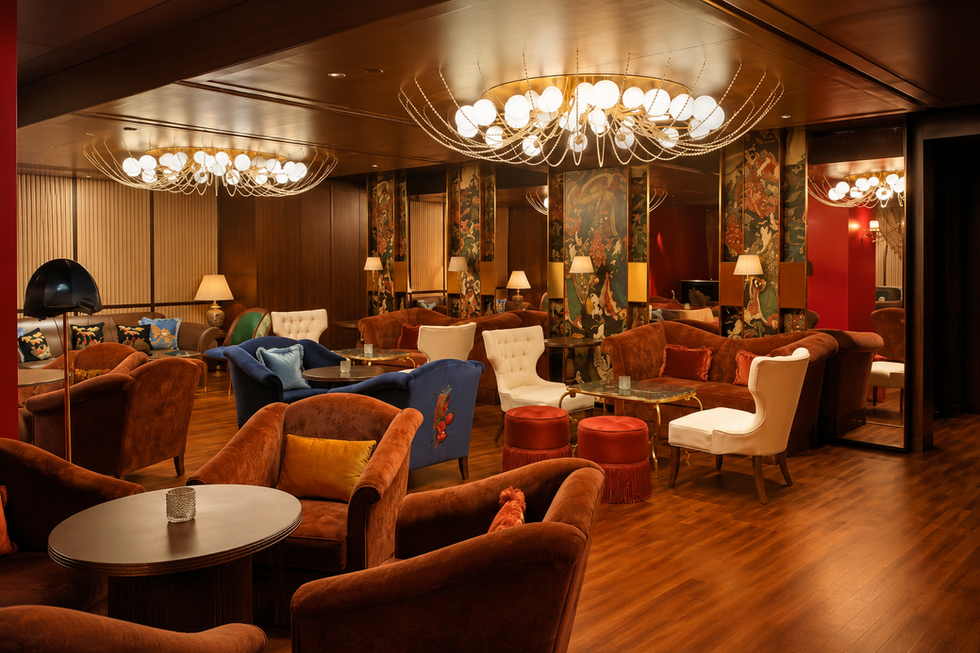 Grand executive hotel lounge with leather armchairs and brass lighting fixtures