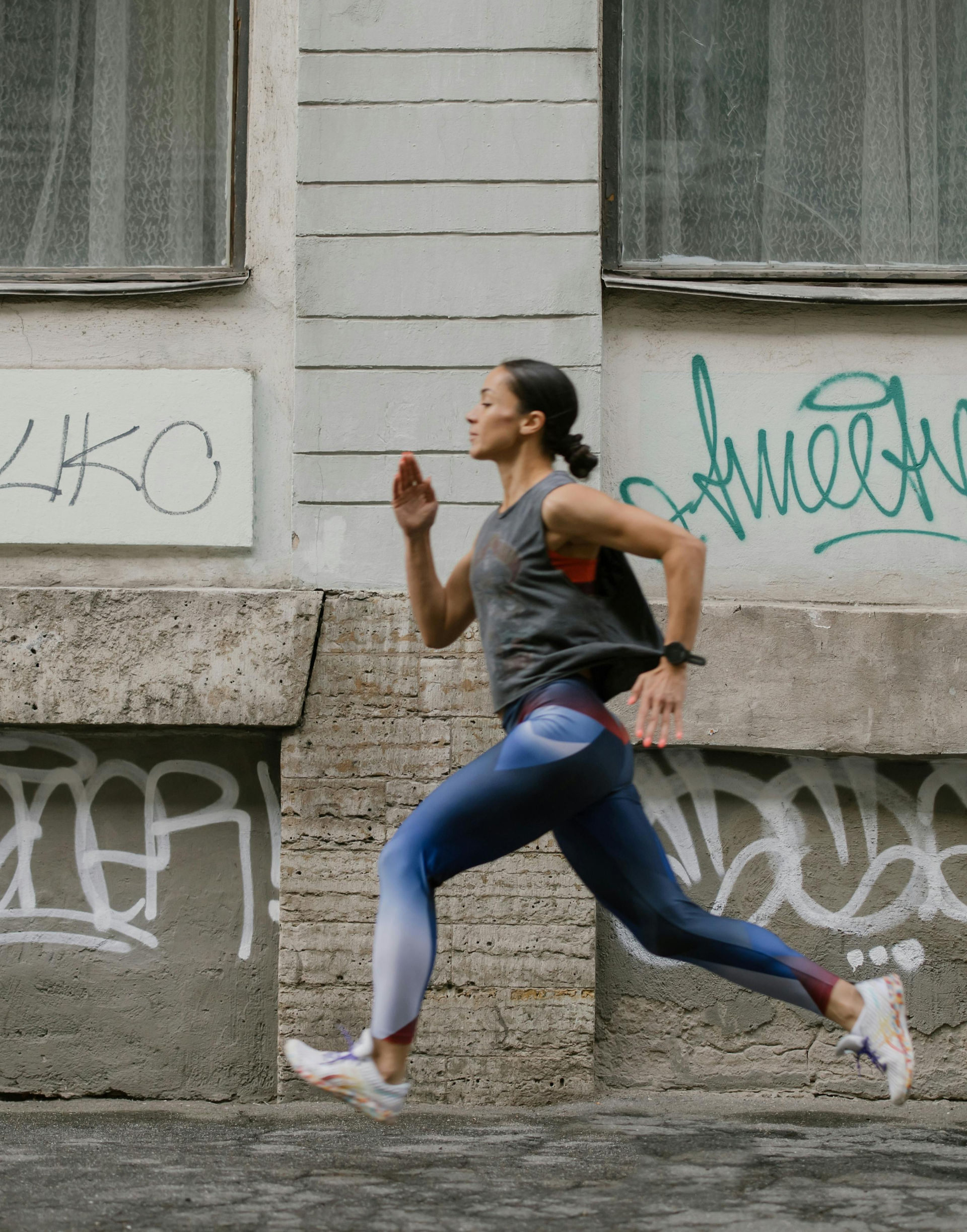 Woman running outdoors, urban backdrop