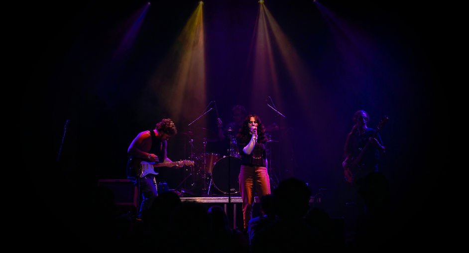 Full band photo in dark lighting