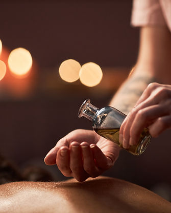 spa-therapist-applying-massage-oil.jpg
