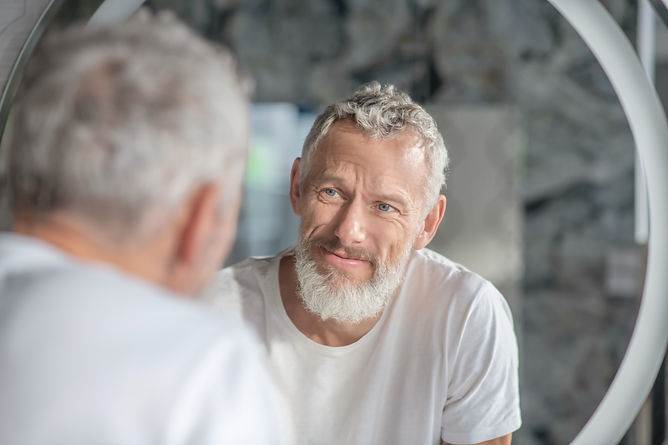 checking-appearance-grey-haired-man-looking-his-reflection-mirror.jpg
