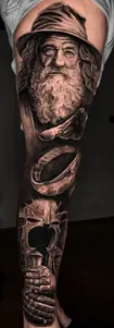 Detailed black and grey realistic leg sleeve tattoo of Gandalf from Lord of the Rings, crafted at Tattoo Factory Antalya.