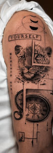 Detailed surrealist tattoo on the upper arm featuring a leopard face, a pocket watch, and abstract geometric lines.