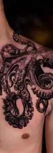 Highly detailed realistic black and grey octopus tattoo stretching across the chest and shoulder with intricate suction cup textures.