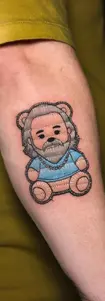 Unique embroidery patch style tattoo of a bearded bear character on an arm, featuring realistic thread textures, Antalya.