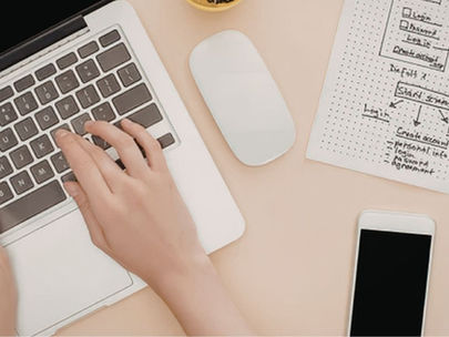 woman using laptop with homepage wireframe