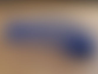 A blue slinky on a wooden floor