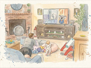 Older brother and baby crawl on a rug in a cozy living room, watching a TV with a koala in a suit; fireplace and family photos nearby.
