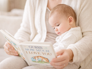 parent reading to baby in a cozy room  quiet reading moment between parent and child