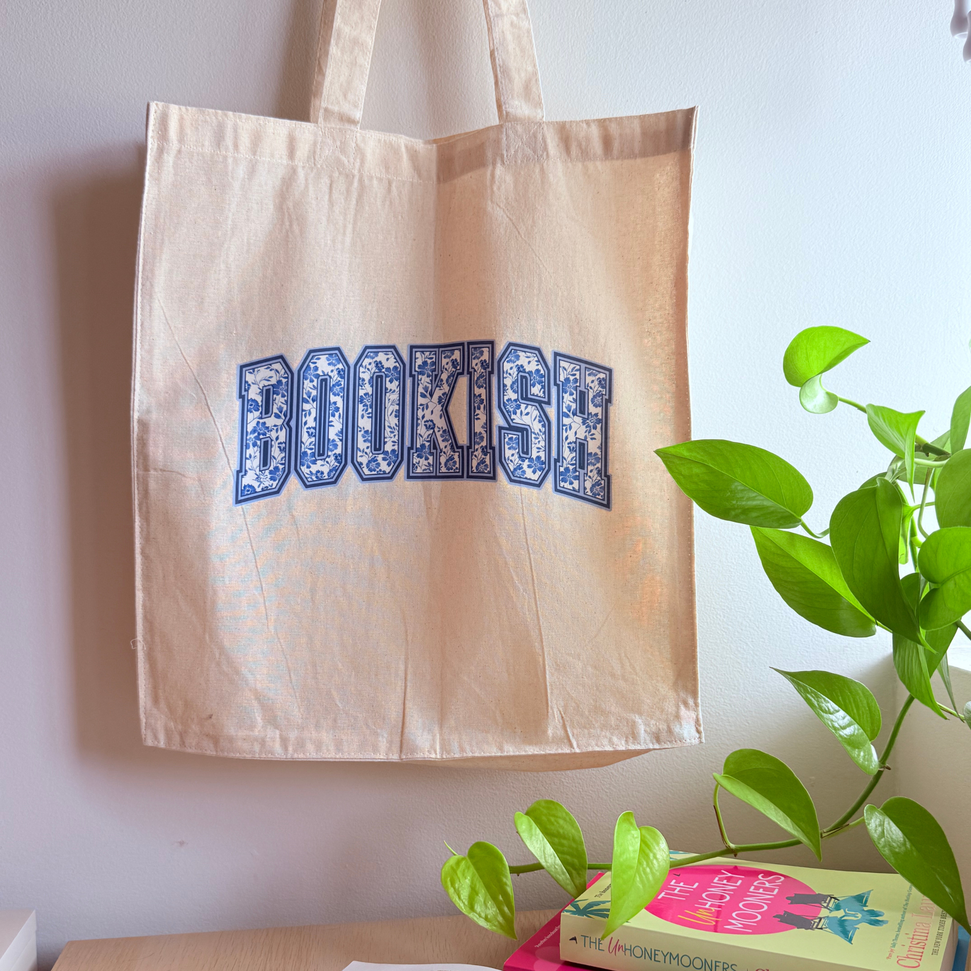 bookish toile pattern image on a neutral colour tote bag
