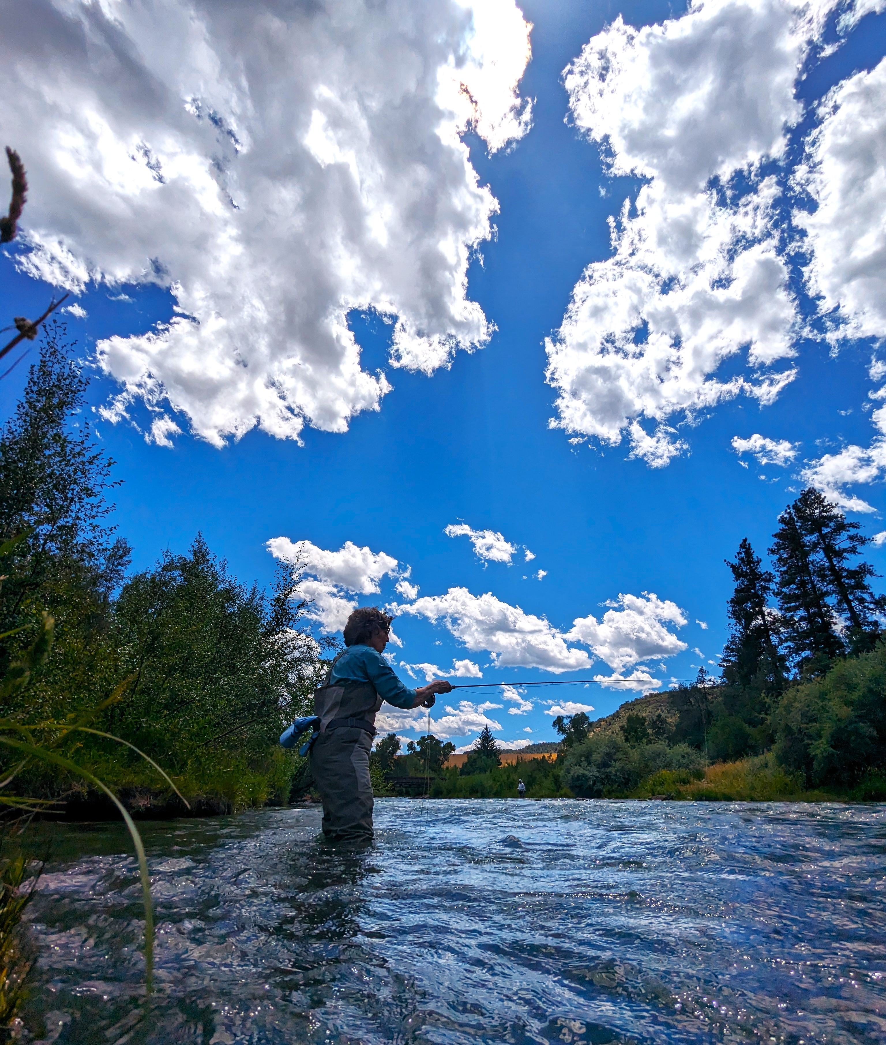 A tranquil river scene at dawn perfect for fly fishing.