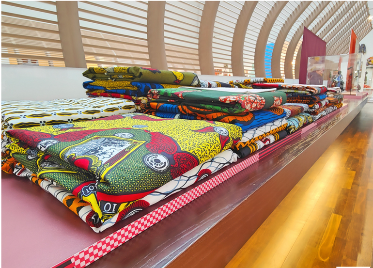 Display of vibrant wax textiles at the Musée de l'Homme. This photograph captures the beauty and diversity of African textiles, inviting viewers to explore the rich heritage and craftsmanship behind these intricate creations.