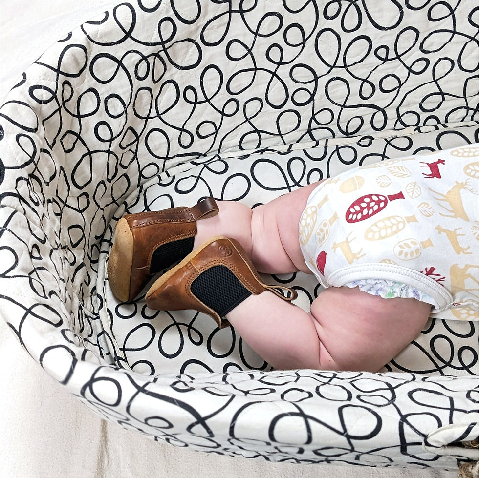 Thumbnail: Handmade leather Chelsea boot for babies in a light brown colour. Shown on a baby in a white fabric basket. 