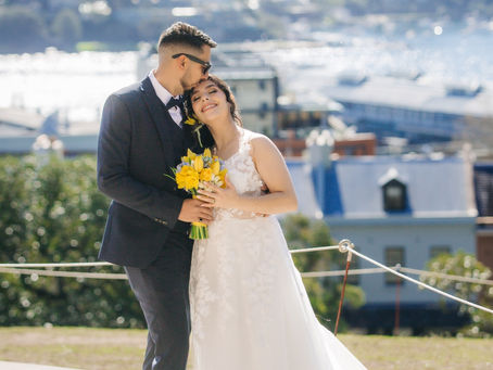 Bride and groom photographed with the Sydney city skyline behind them at a pre-wedding shoot location