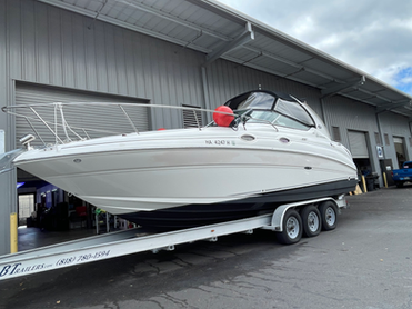 White Sea Ray cruiser on a trailer featuring Tsunami 4.0 ceramic coating.