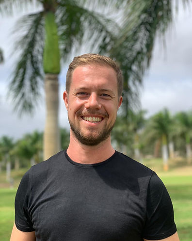 Potrait of Thibaut Ottomer out in the park wearing black T-shirt and smiling at the camera