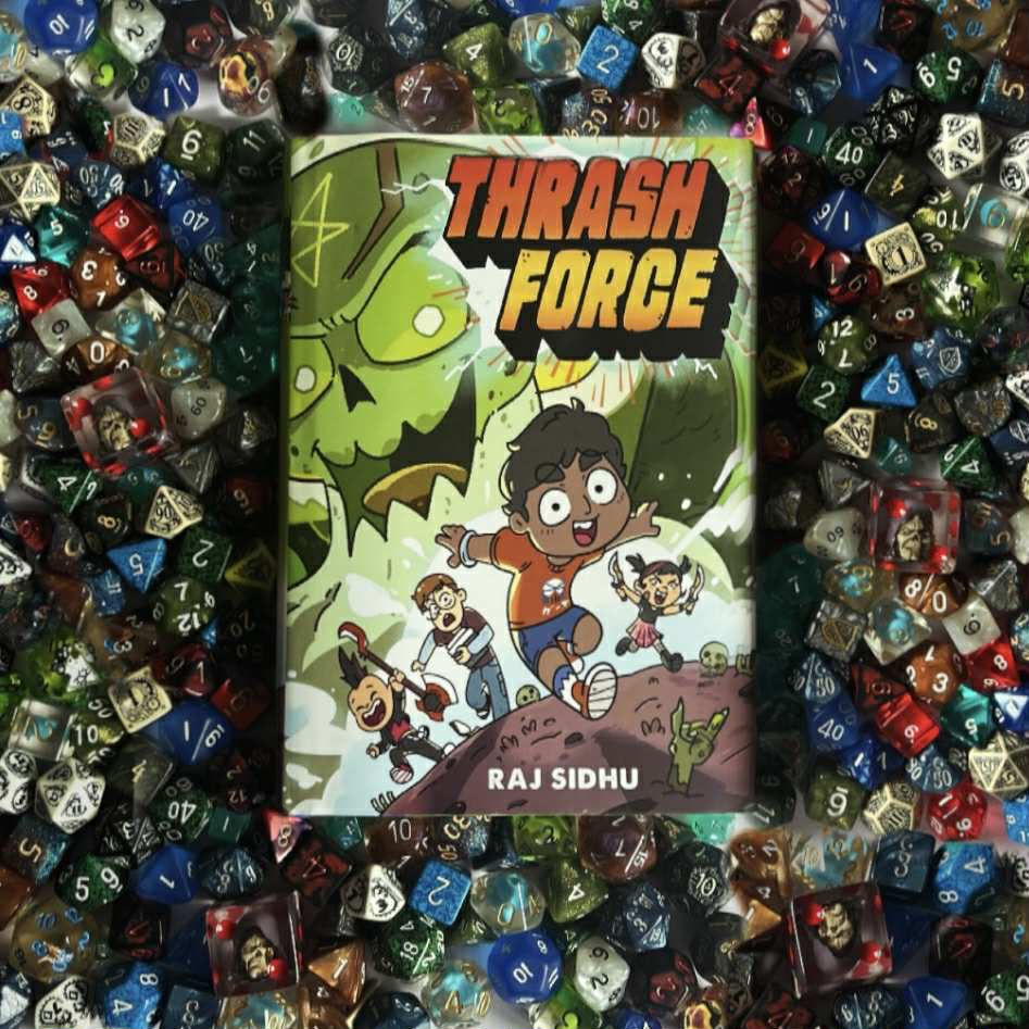 the book Thrash Force by Raj Sidhu on a pile of various dice
