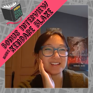 Kendare Blake posing in front of a poster for Girl of Nightmares