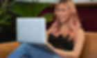 A transfeminine person smiling and using a laptop_edited_edited_edited.jpg