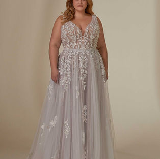 The Lynette designer wedding dress is an effortlessly boho gown with botanical-inspired crystal beaded embroidery and three-dimensional petals.
The delicate tulle floats off the body with a sculptural v-neckline and a crystal beaded waistband to cinch you in and enhance the A-line silhouette