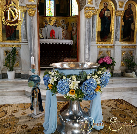 Blue themed baptism font decoration with candles and floral styling