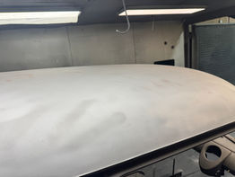 Car roof in a workshop, Adelaide Sandblasting, ready for paint.