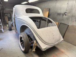 Classic Ford 3 Window Coupe body in a workshop, undergoing restoration process.