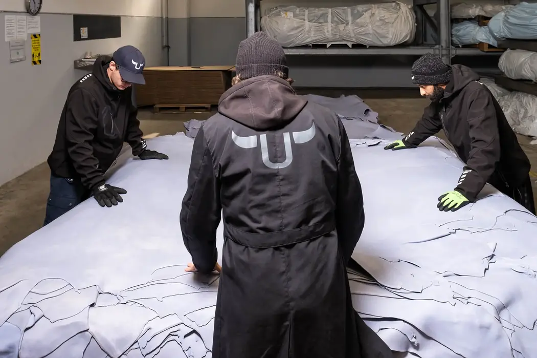 workers trimming leather in wet blue