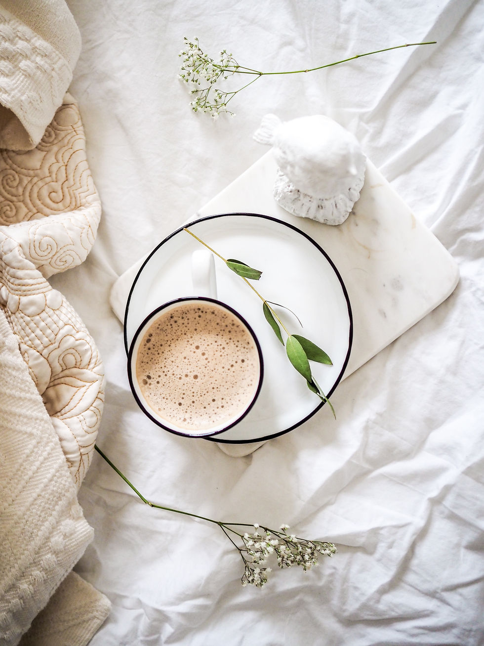 cozy tea setting surrounding by white blankets and yarrow
