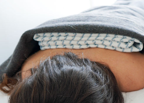 small green leaf in a clear cup of water on white table
