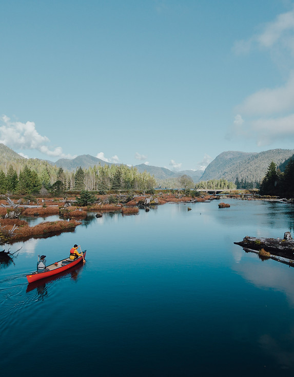 Couple canoeing in the waters of Tofino