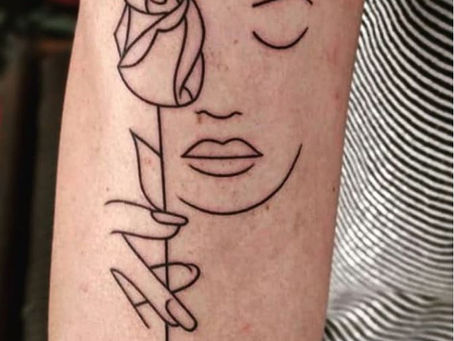 Minimalistic linework tattoo of a lady holding a rose in hand.