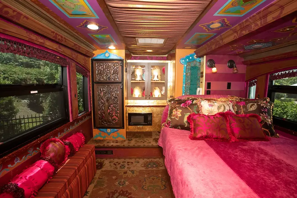 Experience the ultimate sleepover in Dolly Parton's "Coach of Many Colours" at Dollywood's DreamMore Resort! This vibrant tour bus, filled with Dolly's personal touches, offers fans a chance to immerse themselves in her world. For $10,000 for two nights, you can sleep in her bed and explore her iconic wig collection, all while supporting her Imagination Library charity. Don't miss this unforgettable opportunity to live like a legend!