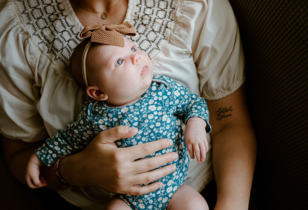 Moody newborn photograph using natural window light in a family home