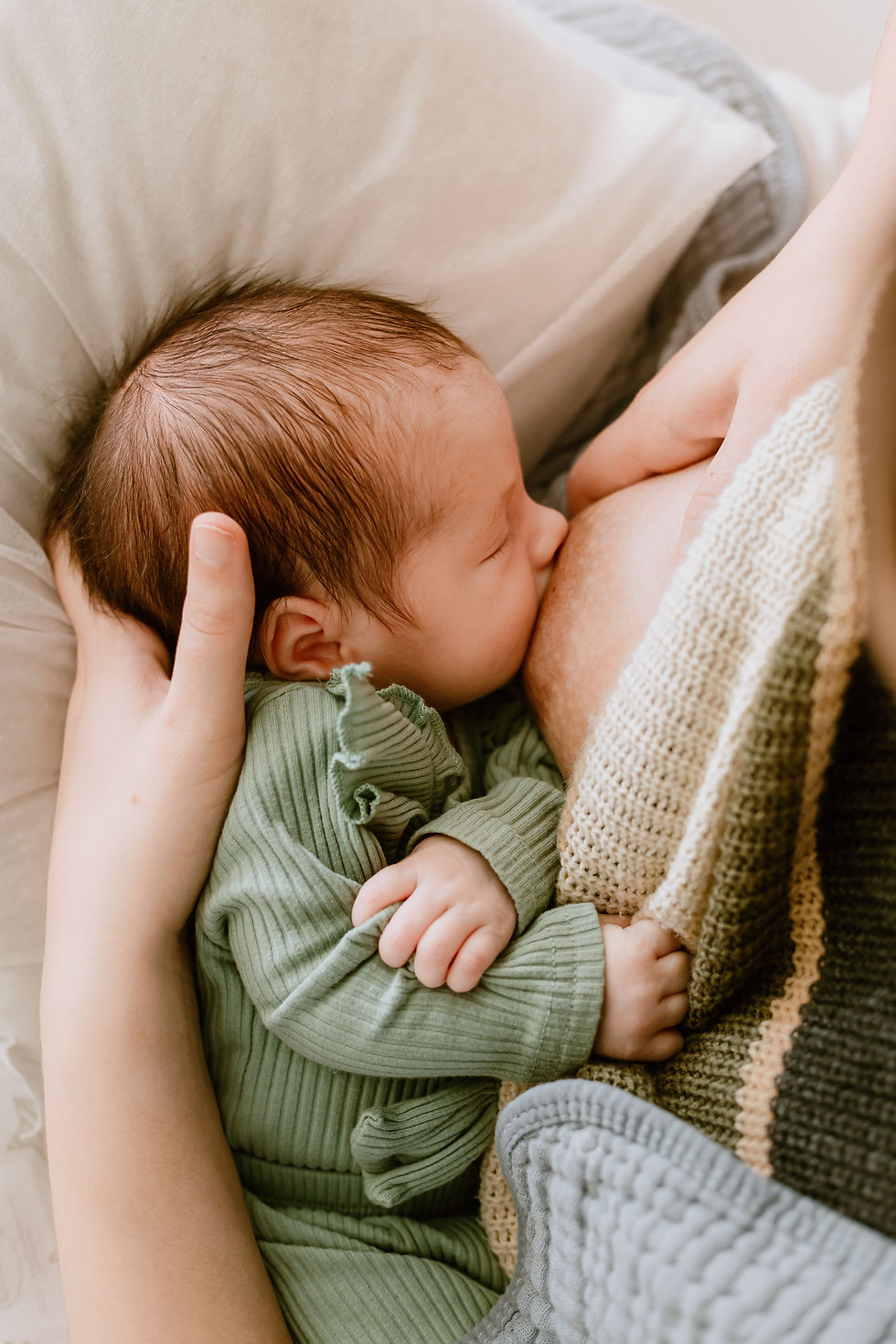 a family snuggles together during an in-home newborn session in delaware