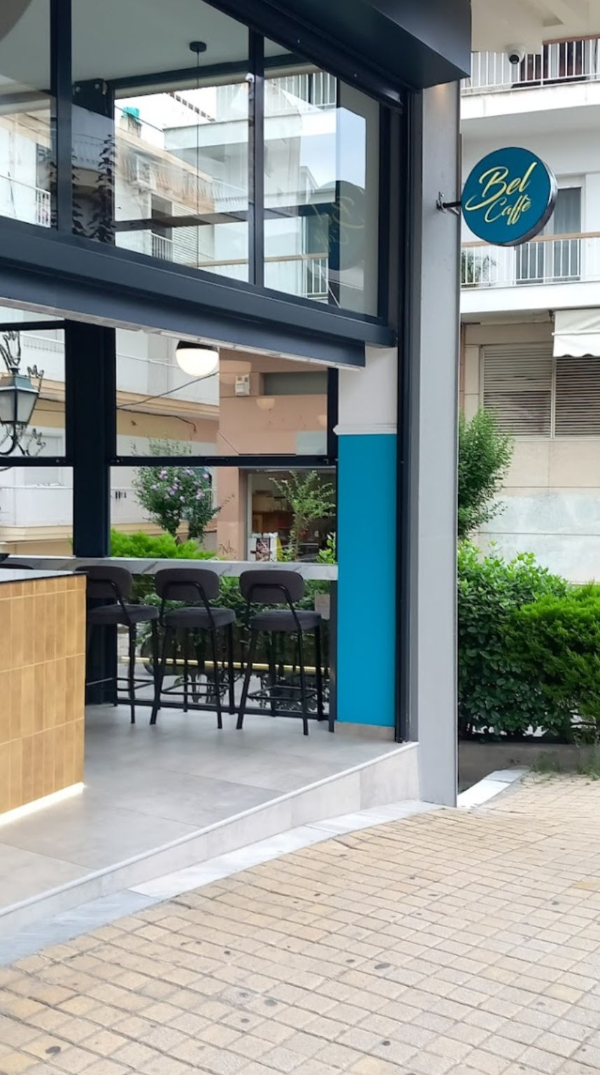 Exterior view of Bel Caffé with open glass façade, turquoise accents, and high bar stools.