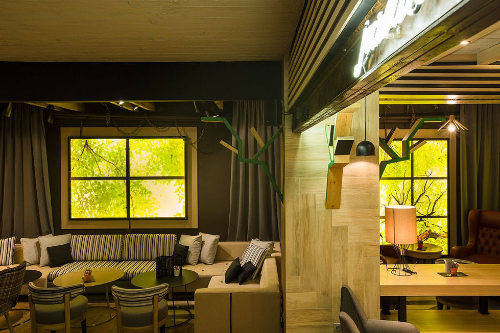 Combination of ambient and task lighting highlighting café bar area with marble counters and modern fixtures.