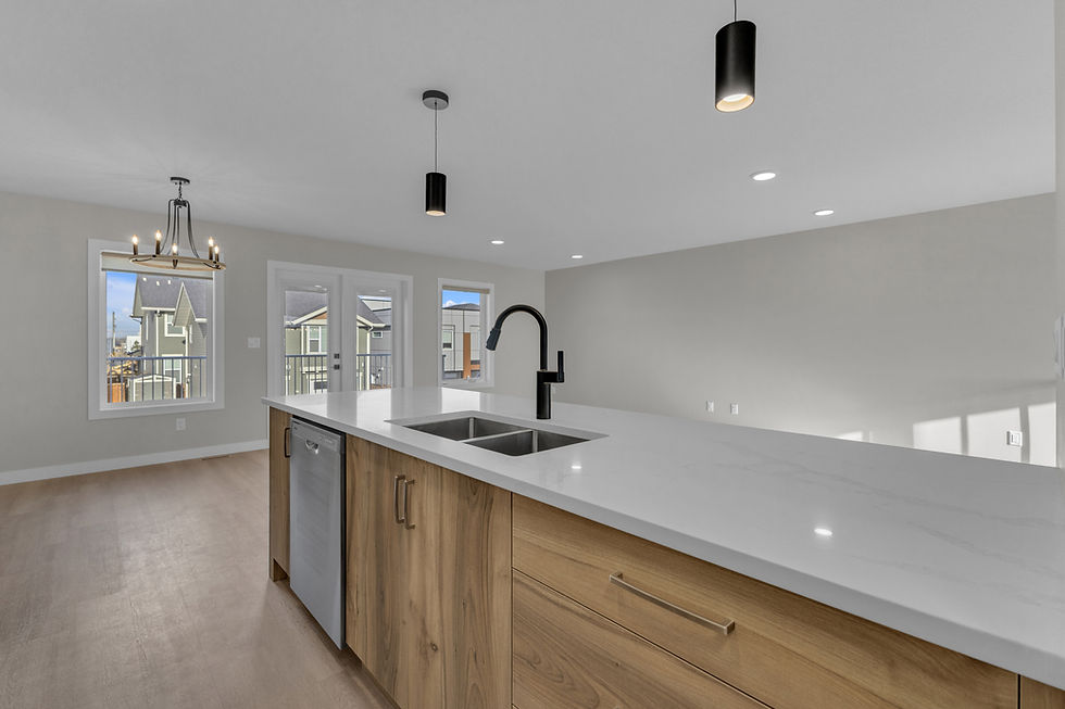 Investment property Red Deer upper level kitchen by Ross Contracting featuring white quartz island warm wood tone cabinets and gold cage pendant chandelier