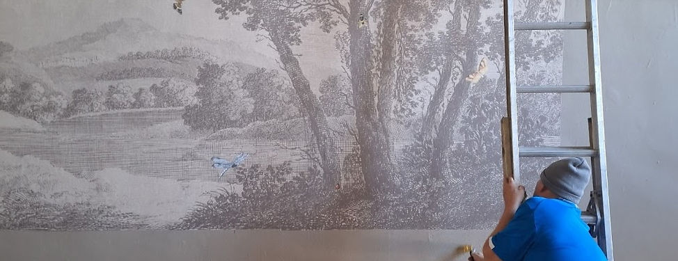 David installing a mural