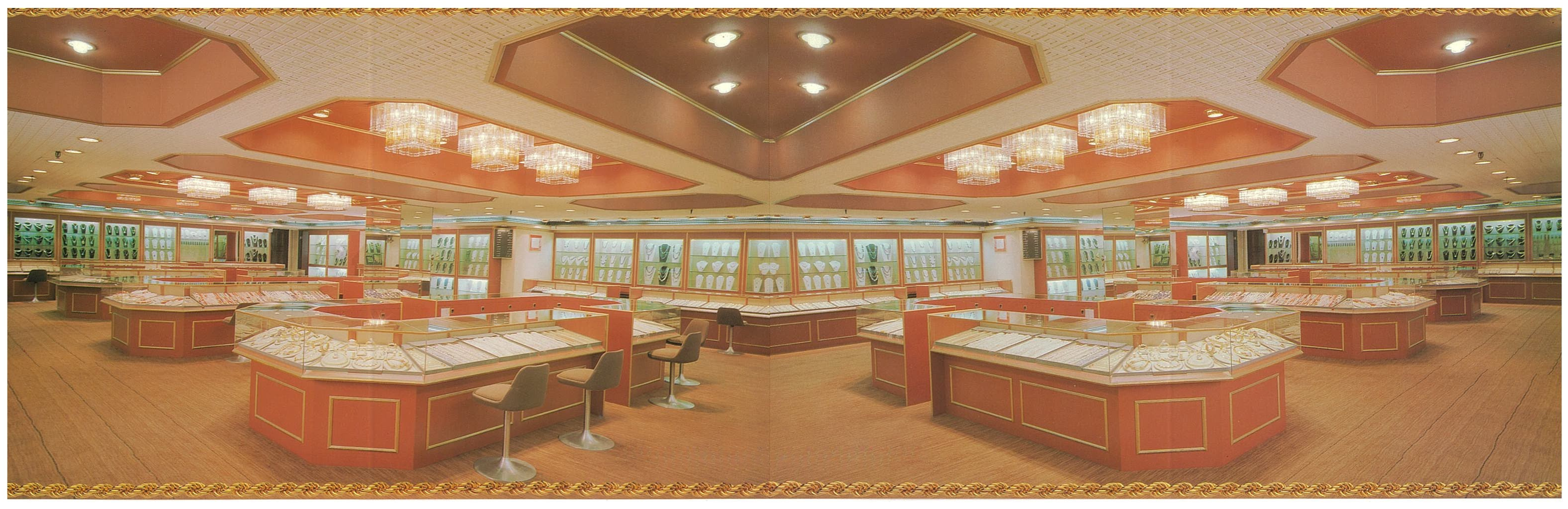 Panoramic view of Aberdeen Jewelry Factory showroom with illuminated display cases and chandeliers