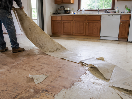 Old linoleum flooring being removed from a Central Oregon kitchen before remodel