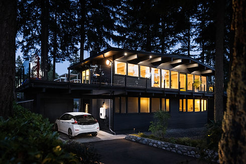 electric car in driveway of house in the woods.jpg