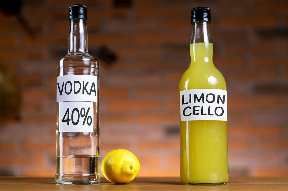 bottle of 40% abv vodka besides a lemon and a bottle of limoncello