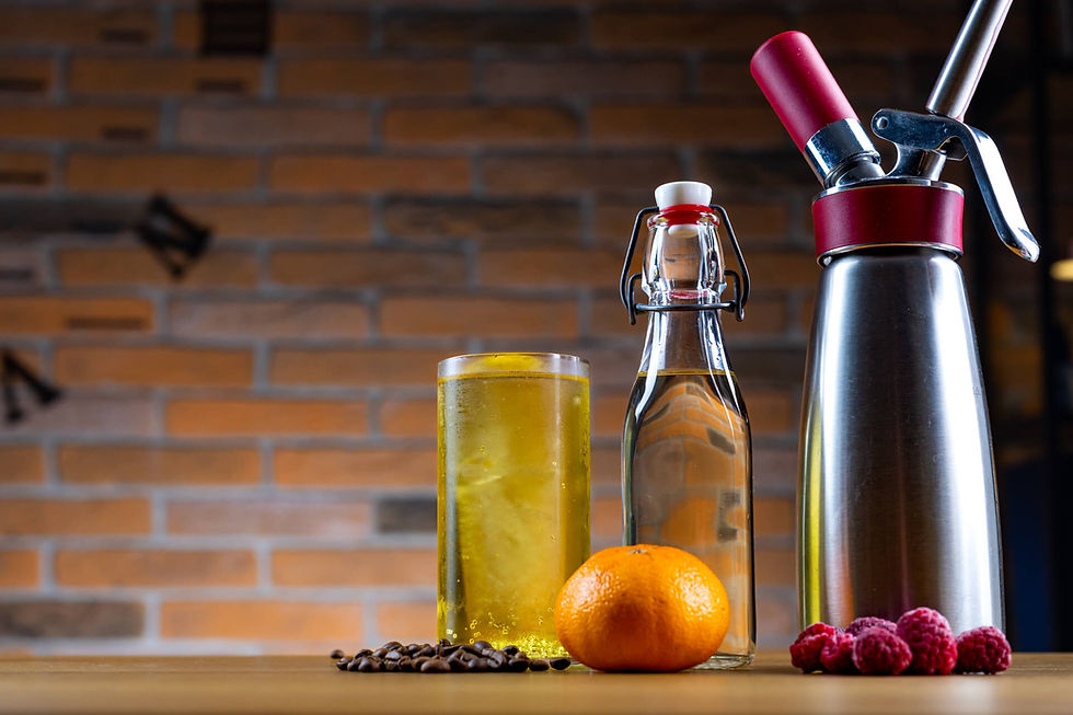 A cocktail, a homemade liqueur, and a cream whipper all showcasing ways to use flat sparkling wine